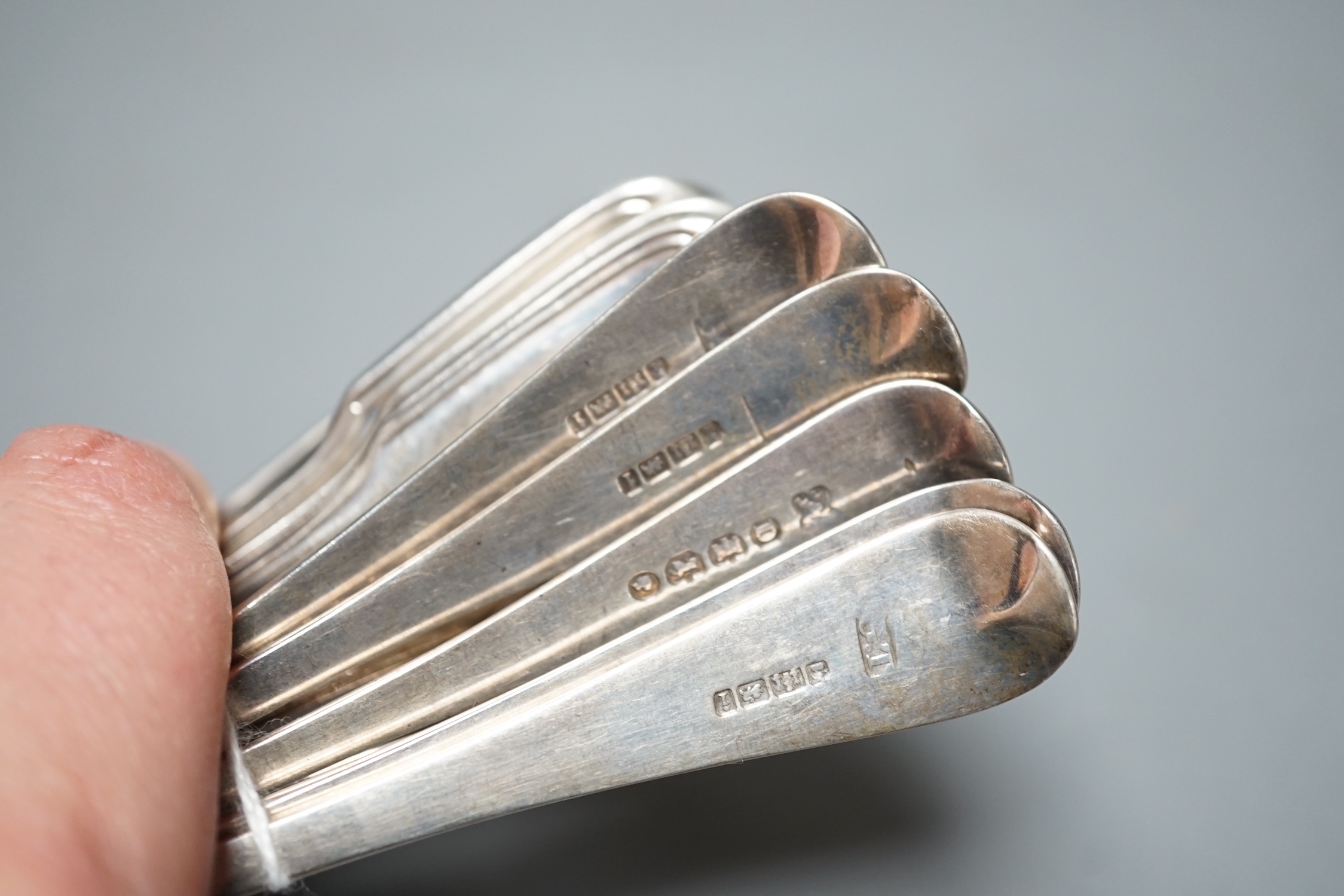 A set of six Victorian silver fiddle and thread pattern teaspoons, London, 1853 and a matched set of six Victorian silver bright cut engraved Old English pattern teaspoons, 9oz.